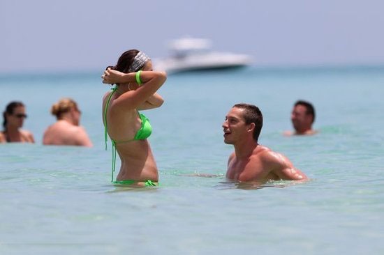 Turkish star player admiring his wife on beach holiday