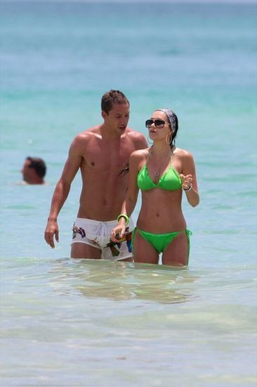 Turkish star player admiring his wife on beach holiday