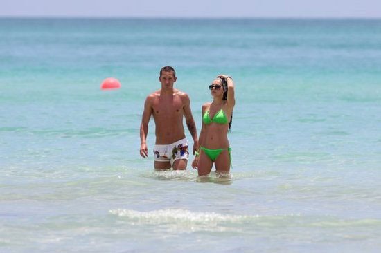 Turkish star player admiring his wife on beach holiday