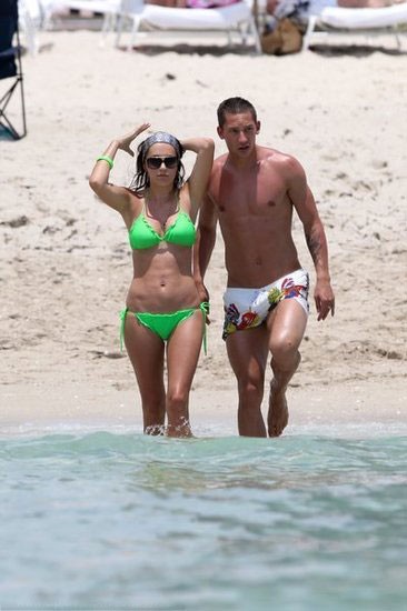 Turkish star player admiring his wife on beach holiday