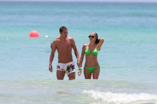 Turkish star player admiring his wife on beach holiday