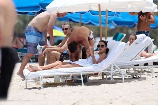 Turkish star player admiring his wife on beach holiday