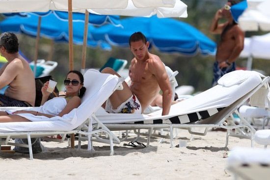 Turkish star player admiring his wife on beach holiday