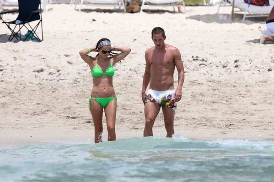 Turkish star player admiring his wife on beach holiday