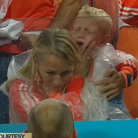 Cute: Arjen Robben consoles crying son with his wife after Holland lose on penalties to Argentina