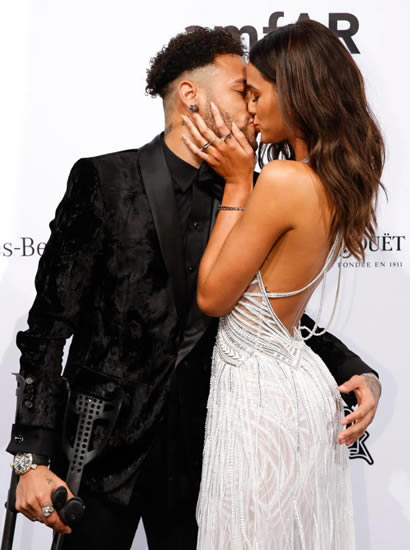 PSG ace Neymar kisses girlfriend Bruna Marquezine as he hobbles on red carpet on crutches at Sao Paulo charity event