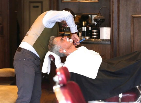 Jose Mourinho cuts lonely figure as he has a close shave with history when popping into posh barbers in Chelsea
