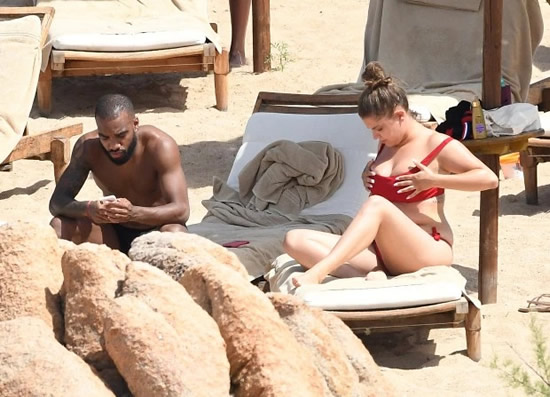 Alexandre Lacazette relaxes on beach with mystery busty brunette ahead of return for Arsenal pre-season
