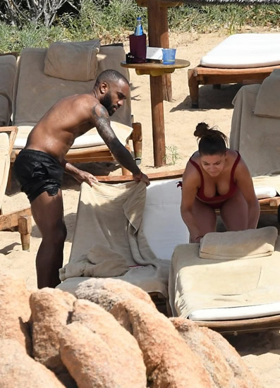 Alexandre Lacazette relaxes on beach with mystery busty brunette ahead of return for Arsenal pre-season