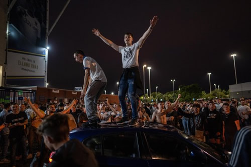 Leeds promoted to the Premier League but celebrations turn sour with cars smashed as thousands flock to Elland Road