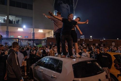Leeds promoted to the Premier League but celebrations turn sour with cars smashed as thousands flock to Elland Road