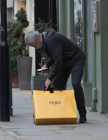 MOUR FOR ME Jose Mourinho sports a face mask as he struggles with his Christmas shopping