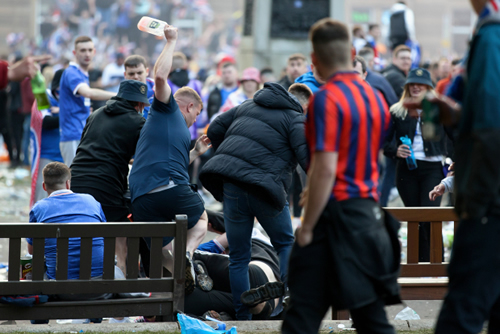 Riot police called to Glasgow carnage as blood-soaked Rangers fans fight with bottles in boozed-up title celebrations