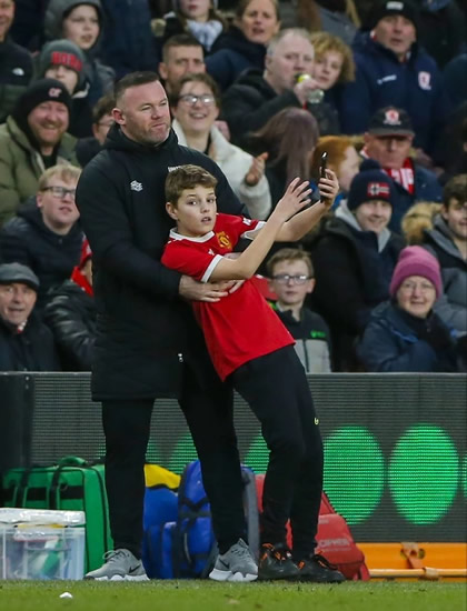 Man Utd legend Wayne Rooney poses for selfie with brazen pitch invader as young fan sprints up wing to dodge stewards