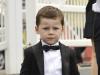 Smart: Kai Rooney, 4, wears a black tuxedo jacket, crisp white shirt and bow-tie for his day out with mother Coleen and brother Klay 