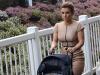 Away at the races: Coleen Rooney makes her way into Aintree with 11-month old son Klay on Saturday 