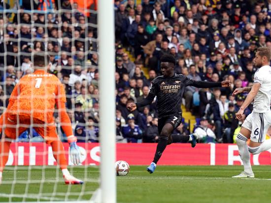 Bukayo Saka fires Arsenal to win as league leaders survive late scare at Leeds