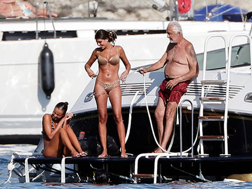F1 supremo Flavio Briatore, 75, appears to flirt with two much younger bikini-clad women on luxury yacht trip alongside his 15-year-old son, after split from ex 49 years his junior