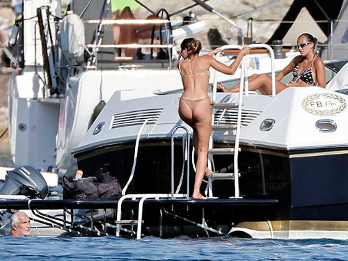 F1 supremo Flavio Briatore, 75, appears to flirt with two much younger bikini-clad women on luxury yacht trip alongside his 15-year-old son, after split from ex 49 years his junior