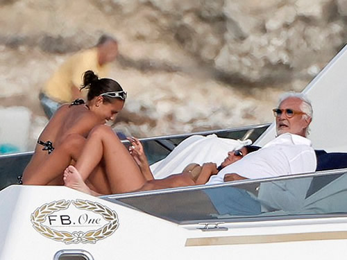 F1 supremo Flavio Briatore, 75, appears to flirt with two much younger bikini-clad women on luxury yacht trip alongside his 15-year-old son, after split from ex 49 years his junior