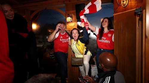 Let the party begin! Arsenal fans descend on Emirates Stadium for wild Premier League title celebrations featuring flags and flares