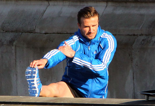 David Beckham goes on the run in London - .. but don't worry, it's for the Olympics!