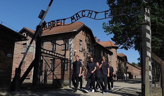 Day football came second: Rooney heads England delegation on emotional tour of harrowing Nazi concentration camp at Auschwitz