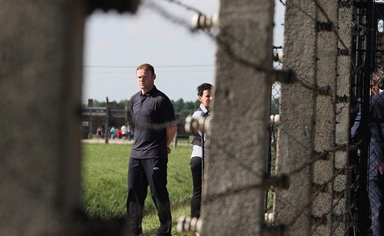 Day football came second: Rooney heads England delegation on emotional tour of harrowing Nazi concentration camp at Auschwitz