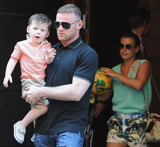 Happy Father's Day! Wayne Rooney takes a break from football at Euro 2012 to enjoy some family time with Coleen and son Kai