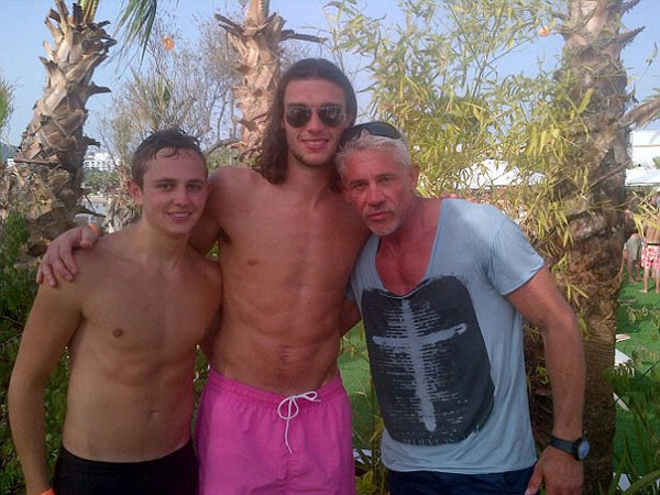 Euro who? England player Andy Carroll lets his hair down and surrounds himself with strikers (of the female variety) in Ibiza
