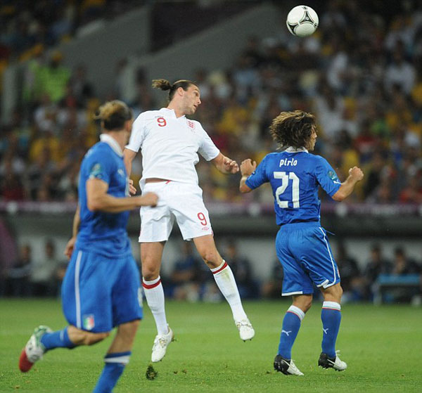 Euro who? England player Andy Carroll lets his hair down and surrounds himself with strikers (of the female variety) in Ibiza