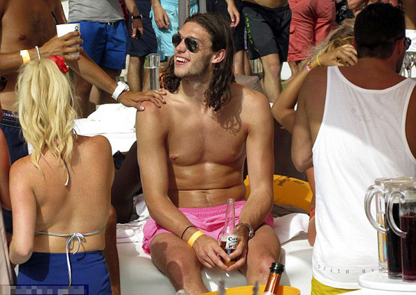 Euro who? England player Andy Carroll lets his hair down and surrounds himself with strikers (of the female variety) in Ibiza