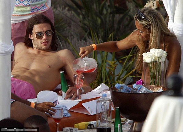 Euro who? England player Andy Carroll lets his hair down and surrounds himself with strikers (of the female variety) in Ibiza