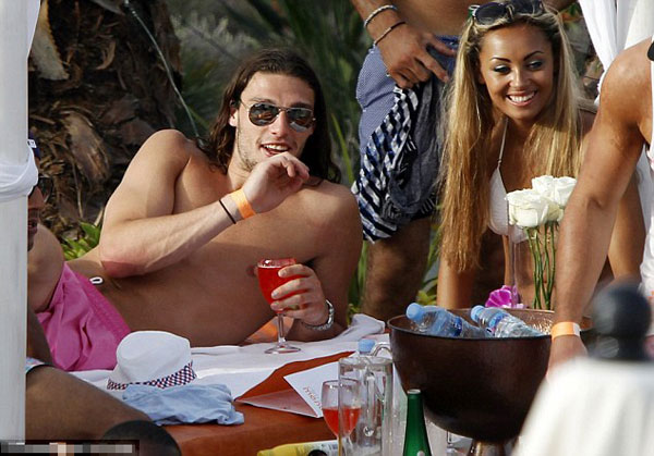 Euro who? England player Andy Carroll lets his hair down and surrounds himself with strikers (of the female variety) in Ibiza