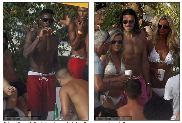 Euro who? England player Andy Carroll lets his hair down and surrounds himself with strikers (of the female variety) in Ibiza