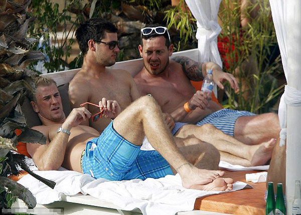 Euro who? England player Andy Carroll lets his hair down and surrounds himself with strikers (of the female variety) in Ibiza