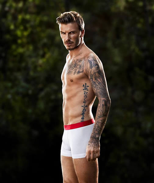 David Beckham shows off his bulging ... muscles