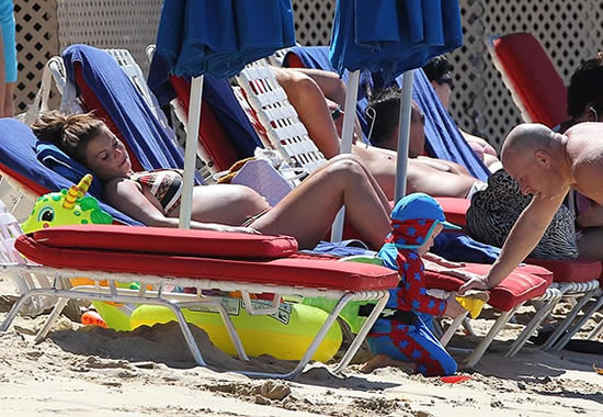 Not travelling light: Coleen in just a bikini – but what’s in all that luggage, then?