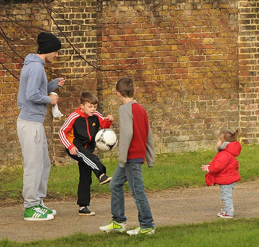 As Posh glams it up at Fashion Week, dressed down David takes his Beckham brood for a kick-about