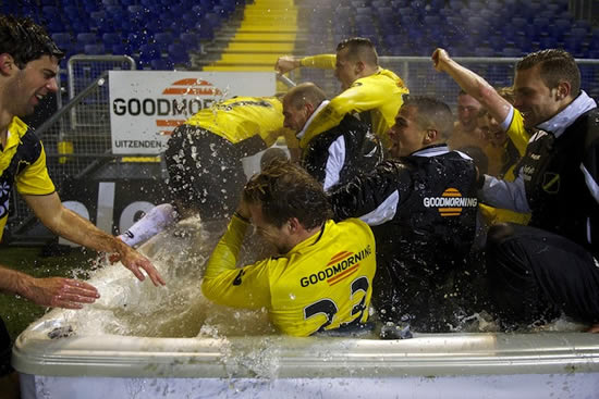NAC Breda players celebrate win in pitchside jacuzzi with fans