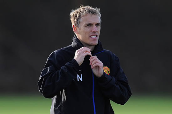 Cheeky Man City fan gives Man United legend Phil Neville some stick on a train