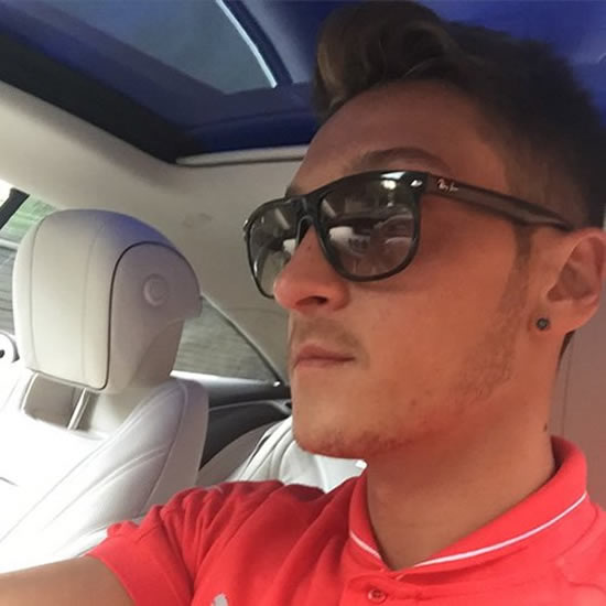 Mesut Ozil drives to meet up with Arsenal squad