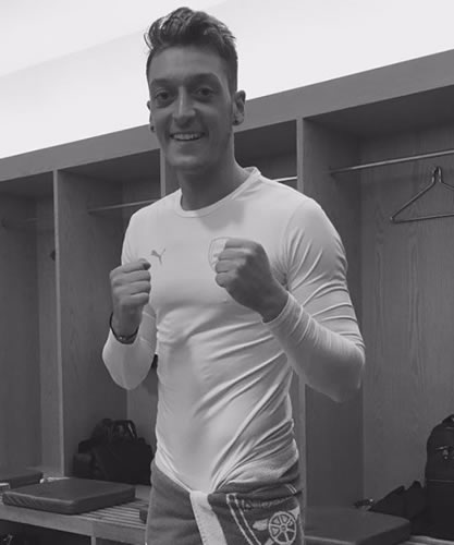 Mesut Ozil all smiles in Arsenal dressing room after Bayern win