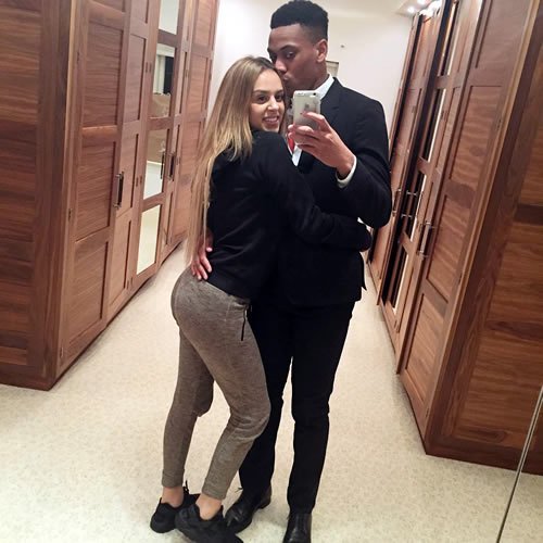 Anthony Martial poses with his wife after Man Utd beat Stoke