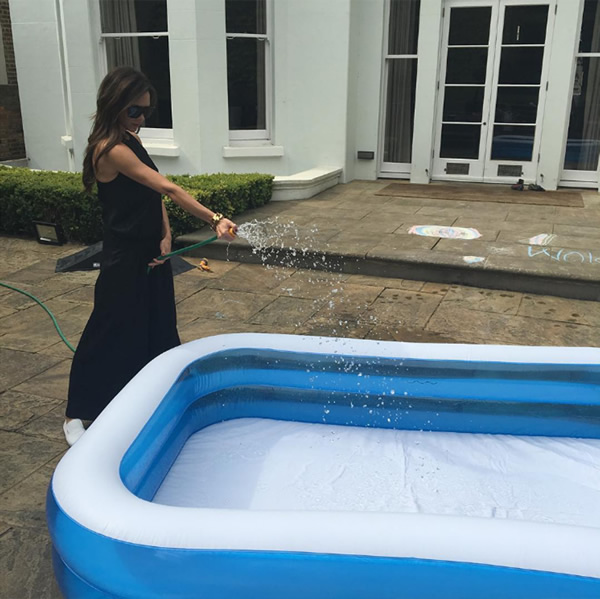 Victoria Beckham earns 'major mummy points' by filling a paddling pool for her kids as Britain basks in weekend heatwave