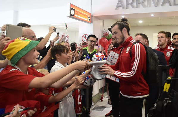 HOME SWEET HOME Welsh soccer heroes touchdown to massive welcome on return to Cardiff