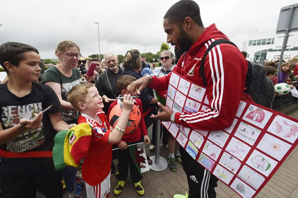 HOME SWEET HOME Welsh soccer heroes touchdown to massive welcome on return to Cardiff