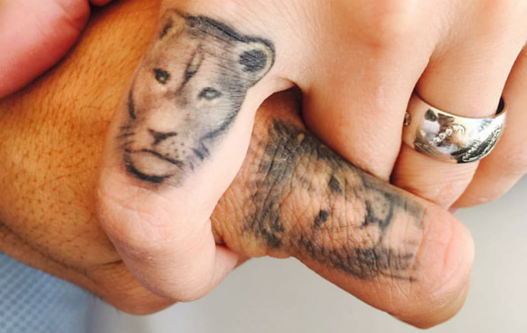 Luis Suarez and his wife get lion finger tattoos