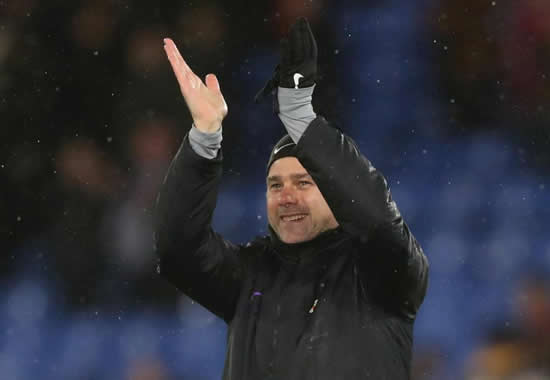 Tottenham boss Mauricio Pochettino cuts his face after struggling with coat in torrential rain