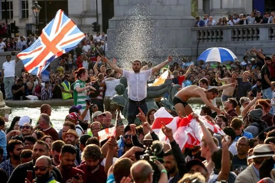 Watch Zlatan Ibrahimovic lookalike fall into Trafalgar Square fountain during cricket World Cup celebrations as he takes on fellow reveller